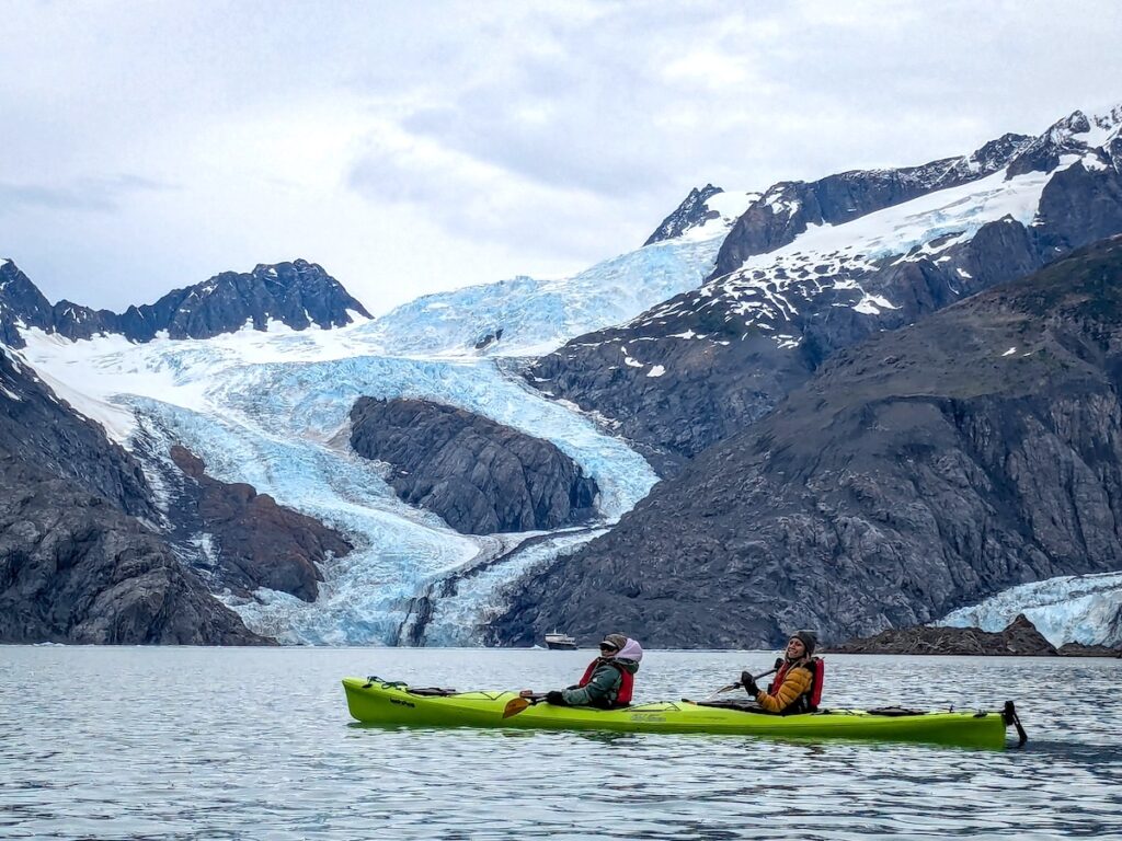 Two Explorer Chicks sea kayaking in Alaska on a women's guided Alaska trip