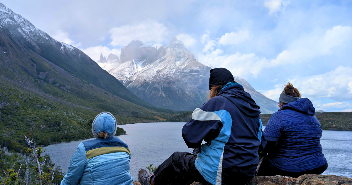 Women hikers overlooking the mountains and lakes of Torres del Paine National Park in Patagonia, Chile