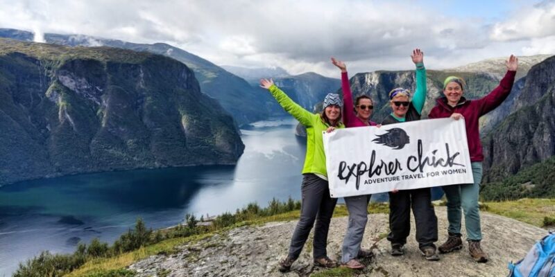 women in Norway holding up an Explorer Chick banner