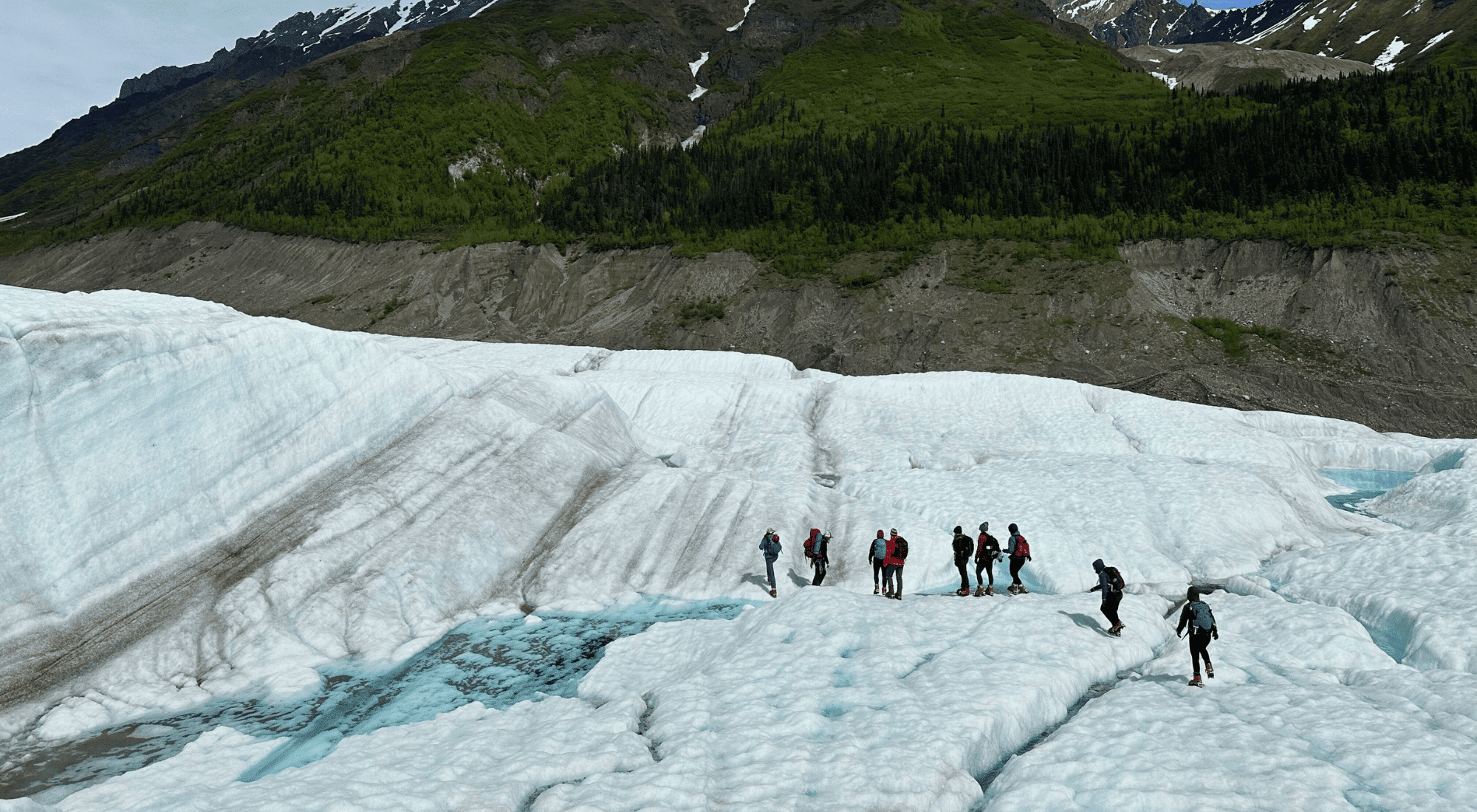 Girl scouts climbing a piece of ice on an island