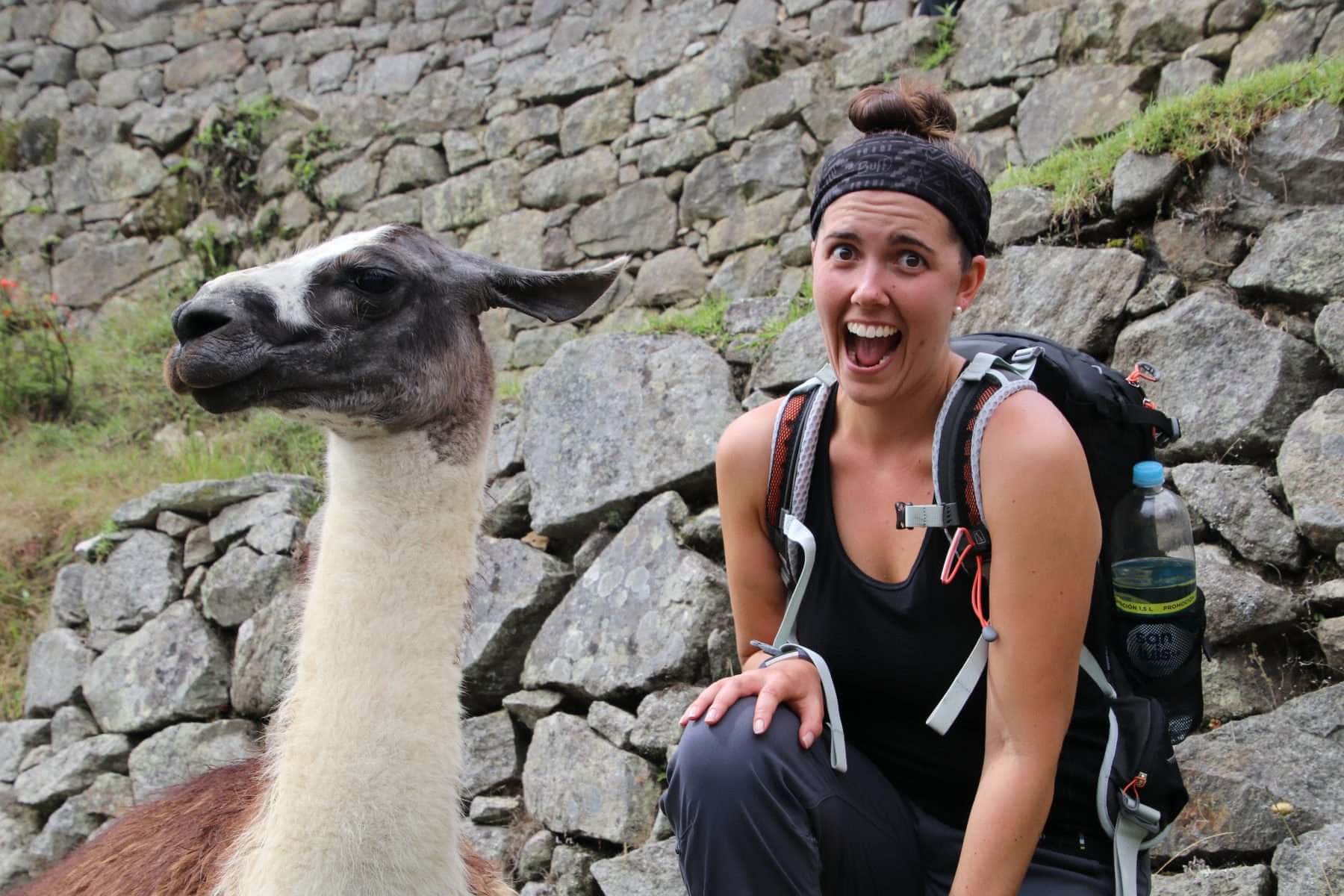 woman posing with a llama on a hiking adventure
