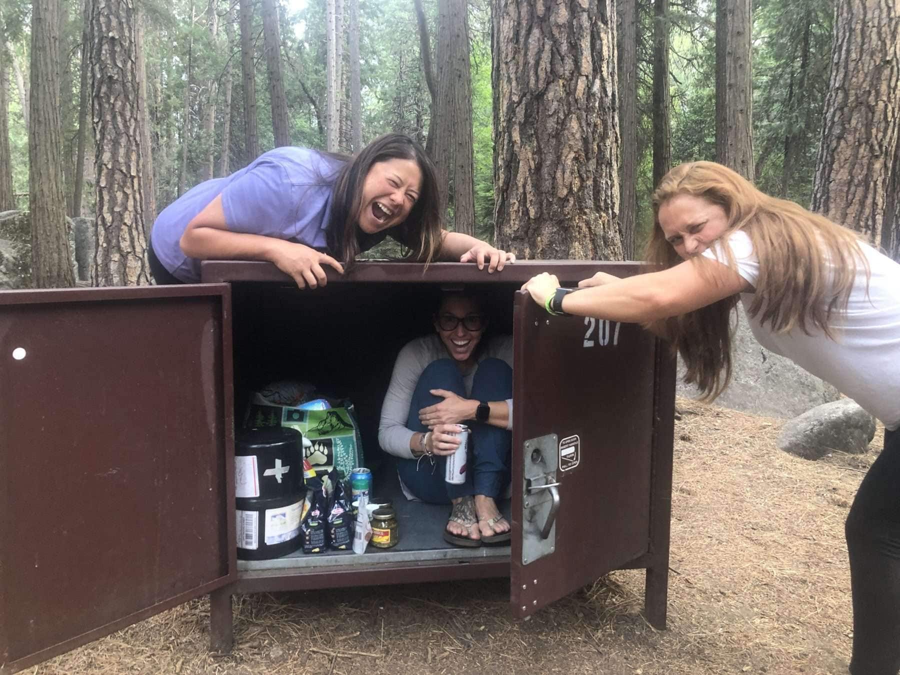 Women opening a cabinet and laughing during a camping trip in Yosemite National Park