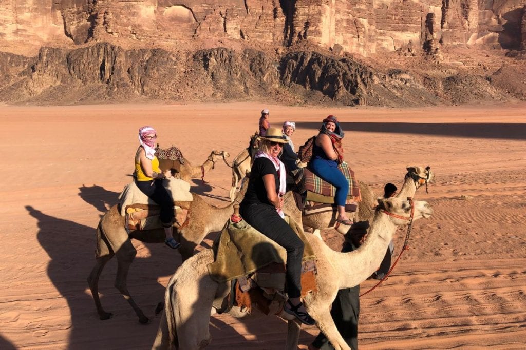 Explorer Chicks riding camels through the canyons of Jordan