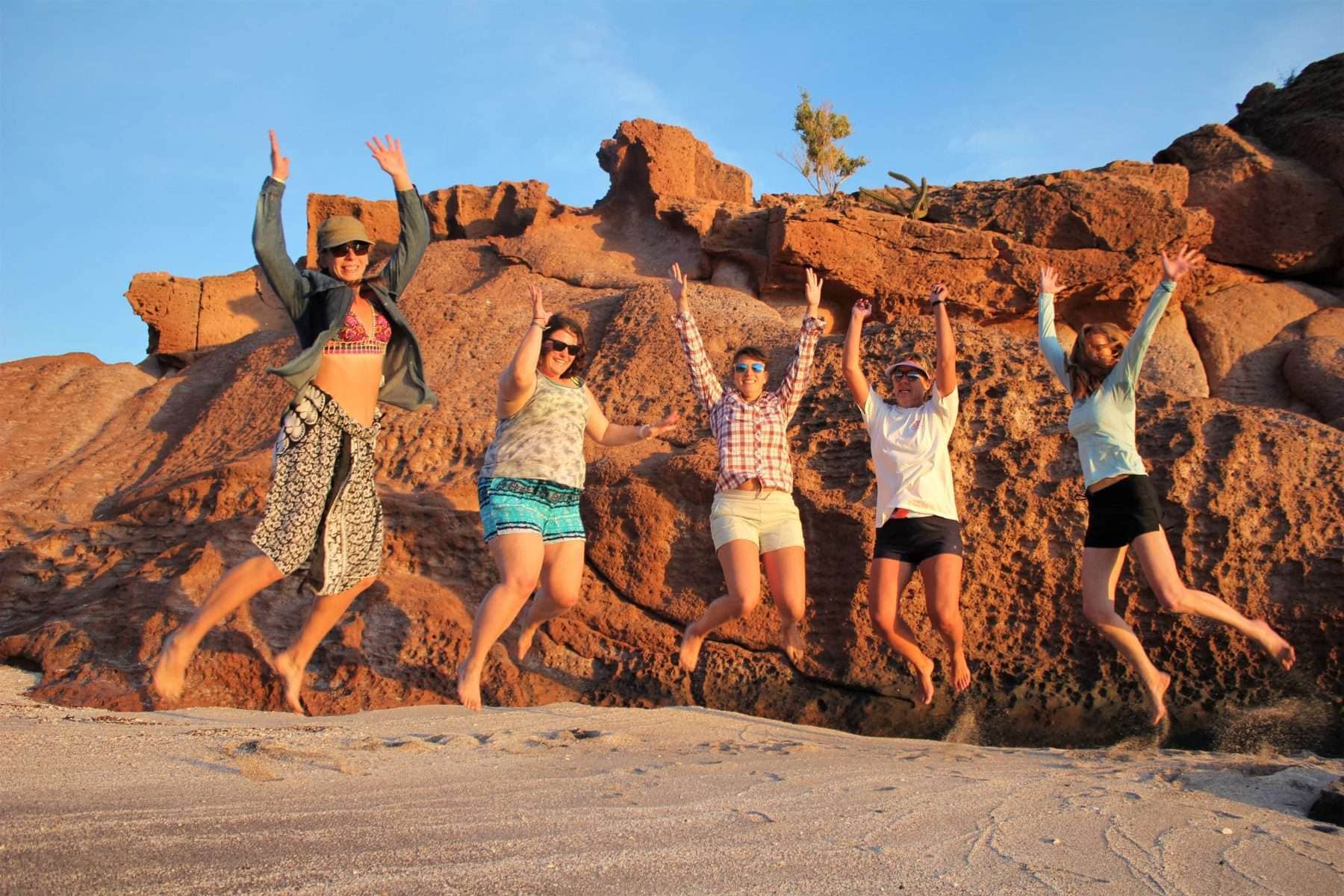 sunset group jump shot women only adventure travel
