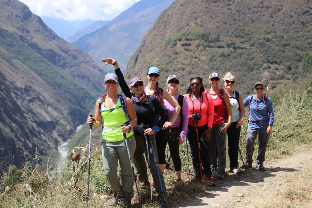 A group of Explorer Chick women on a mountainous hiking trail