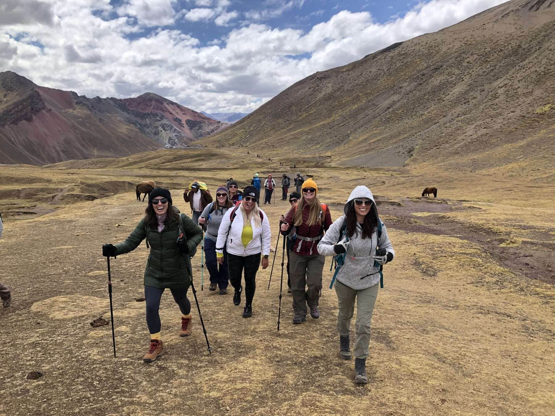 women hiking to rainbow mountain