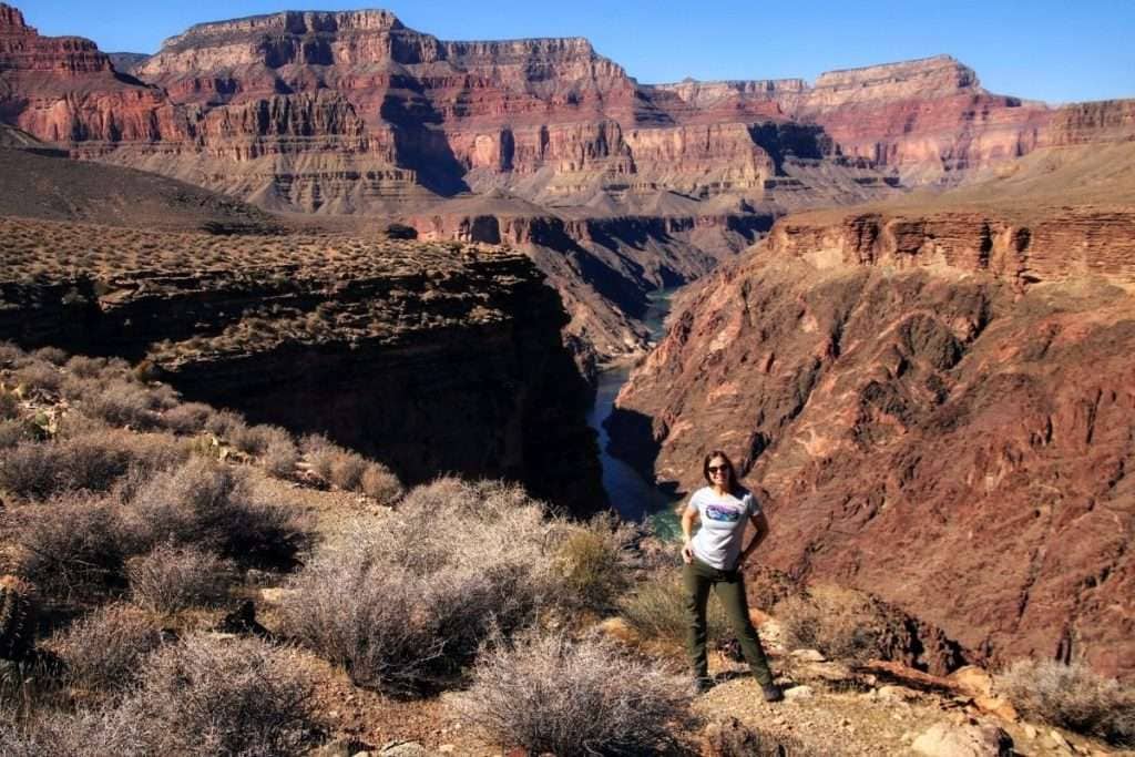 An Explorer Chick woman smiles hiking in Zion National Park