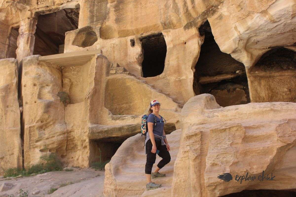 woman poses in front of The Great Temple in Petra, Jordan