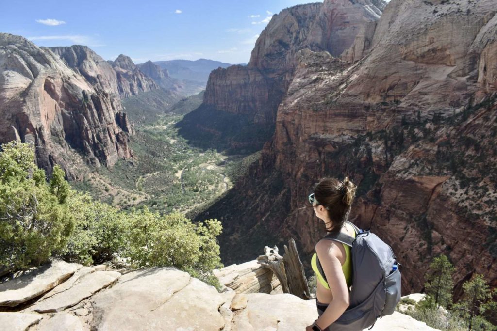 A woman hiking in Zion National Park on an Explorer Chick guided women's hiking trip in Utah