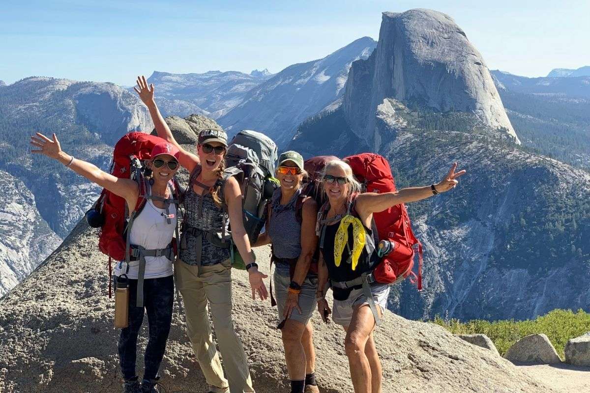 women hiking to the top of a mountain