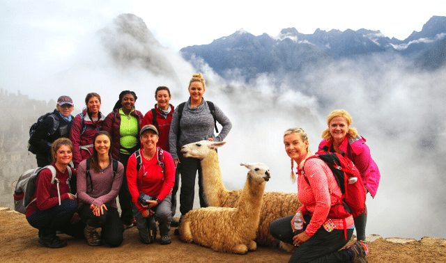 women posing with llamas at Machu Picchu