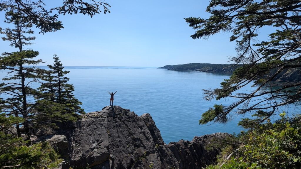 An Explorer Chick hiking in Maine on a women's adventure travel tour