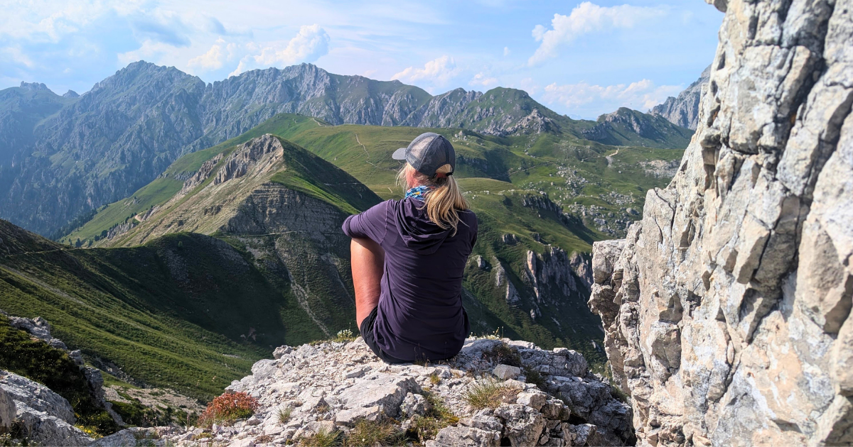 Woman overlooking the Dolomites during an Explorer Chick small-group hiking adventure in Italy