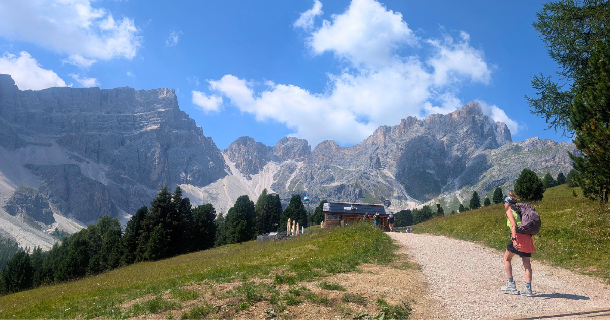 Woman hiking beneath limestone peaks on a small-group women’s tour of the Italian Dolomites