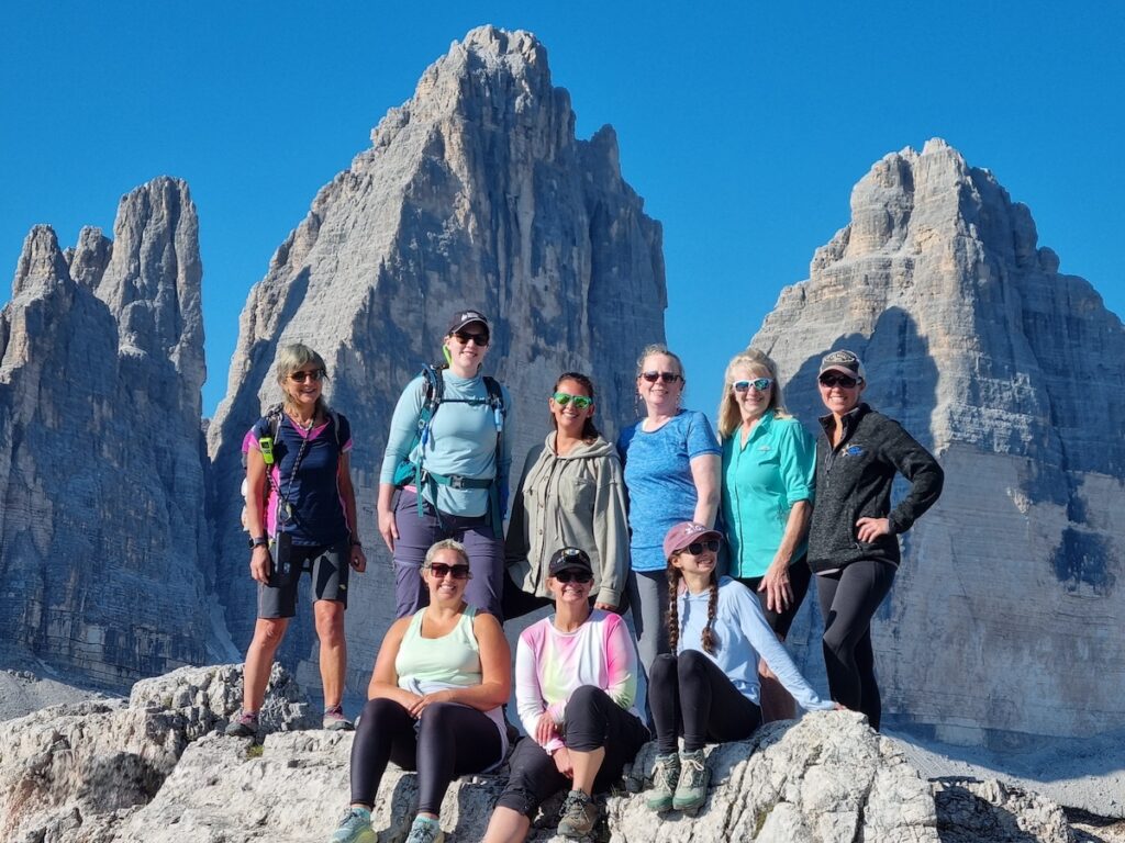 A group of Explorer Chick women hiking in the Dolomites in Italy on a women's group travel tour to the Dolomites