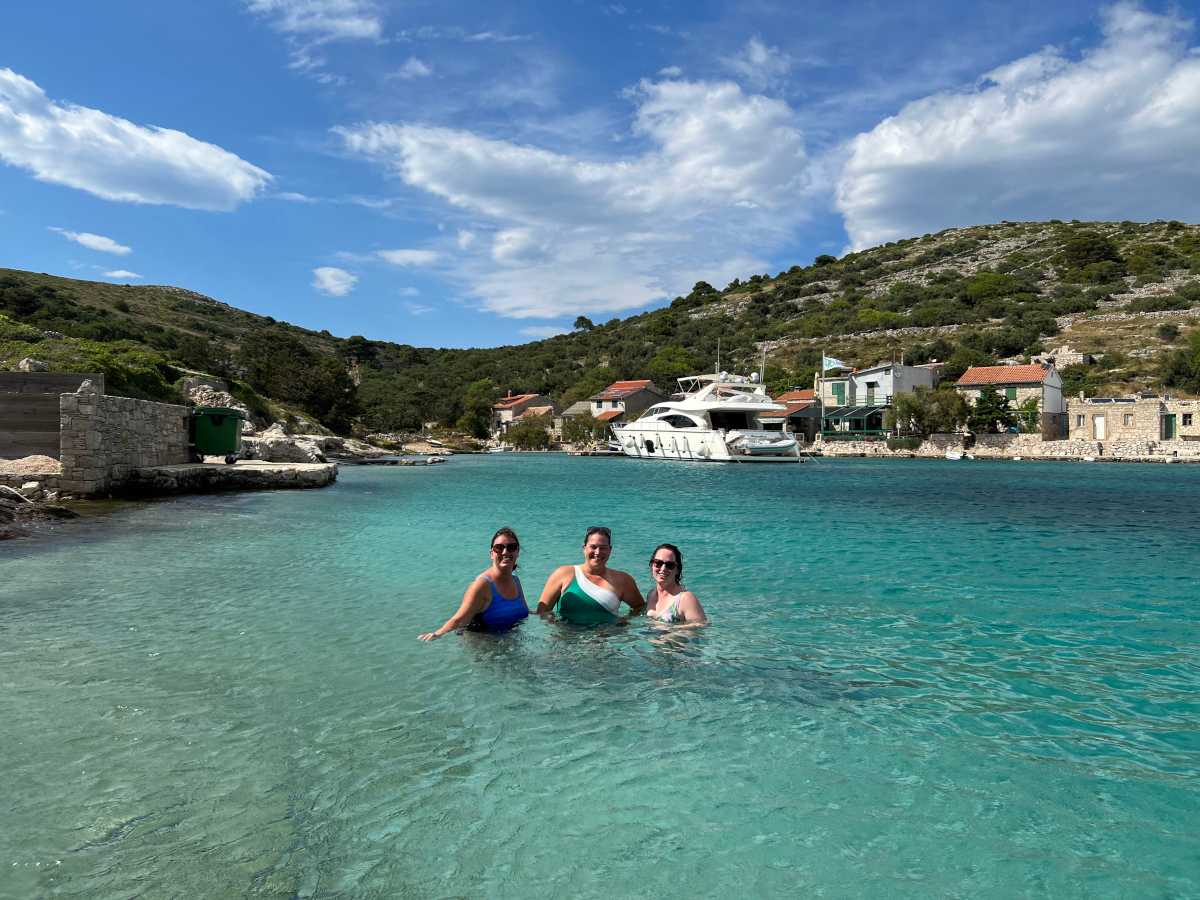 A group of explorer chick women enjoying swimming at the beach in Croatia on a guided adventure travel trip to Croatia