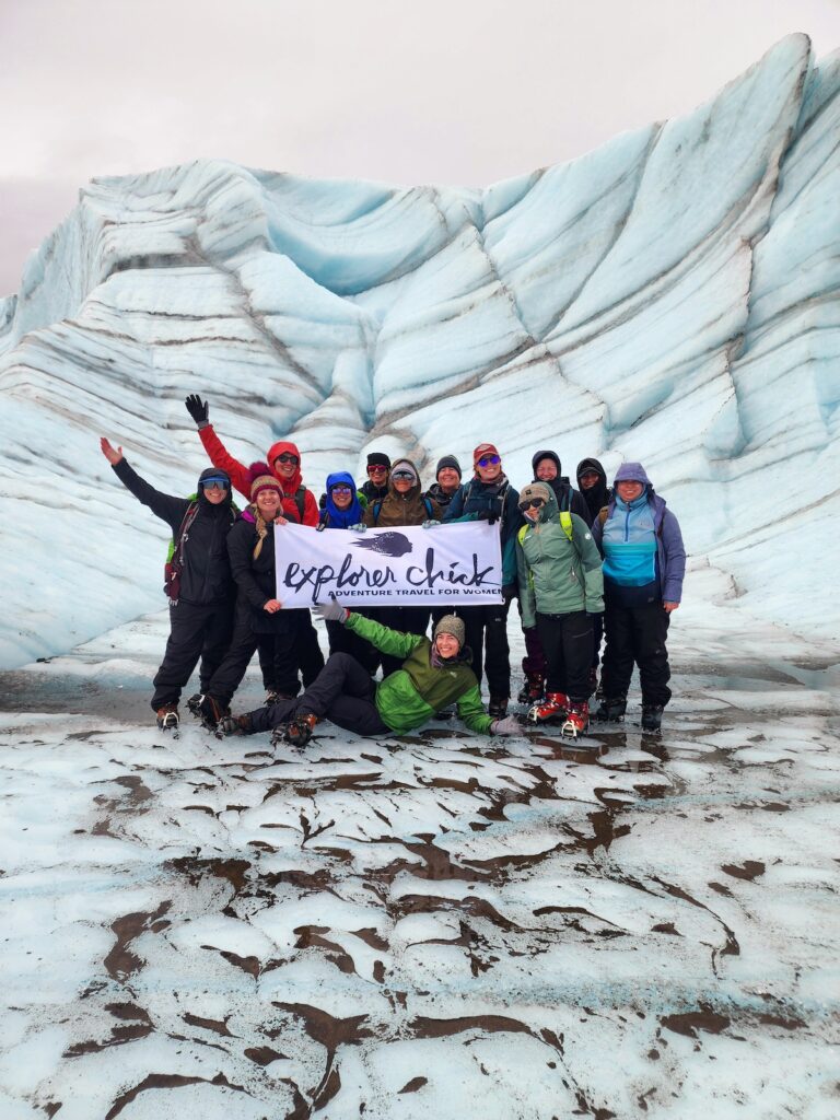 A group of Explorer Chick women on a women-only guided Alaska trip hiking to a glacier