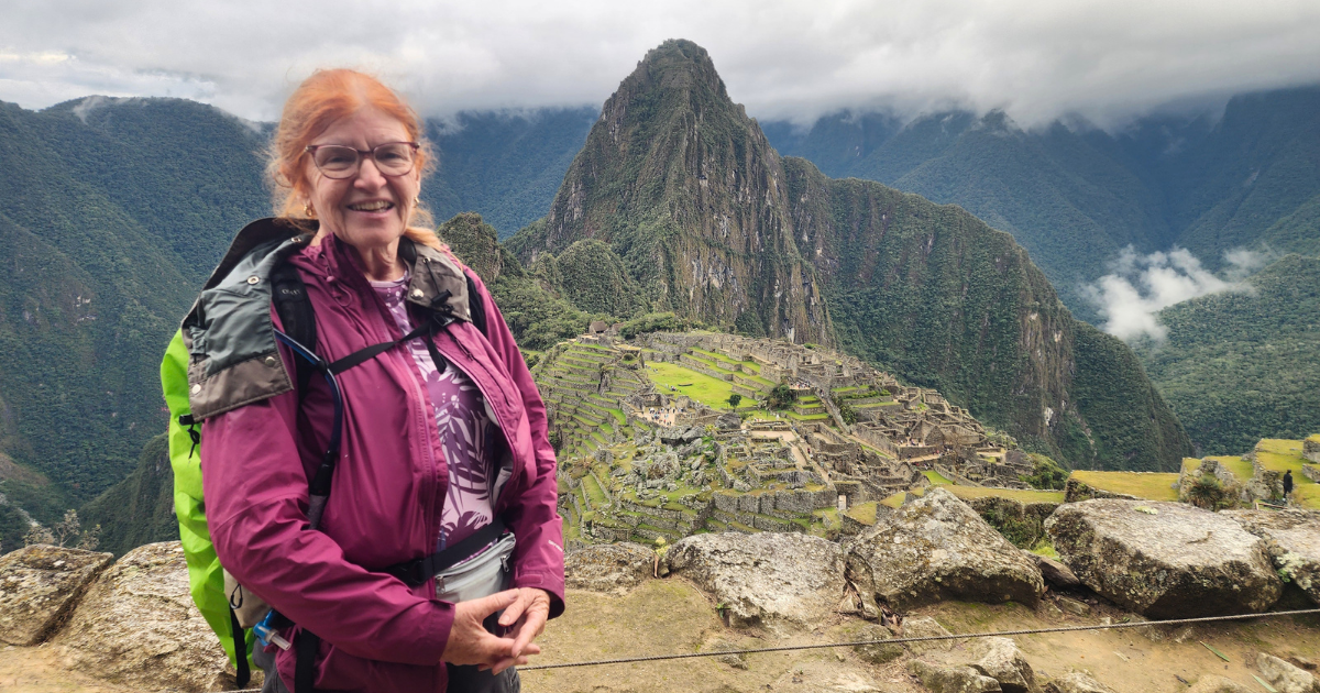 Woman hiking the Inca Trail overlooking Machu Picchu Peru on an Explorer Chick small-group guided women’s hiking trip