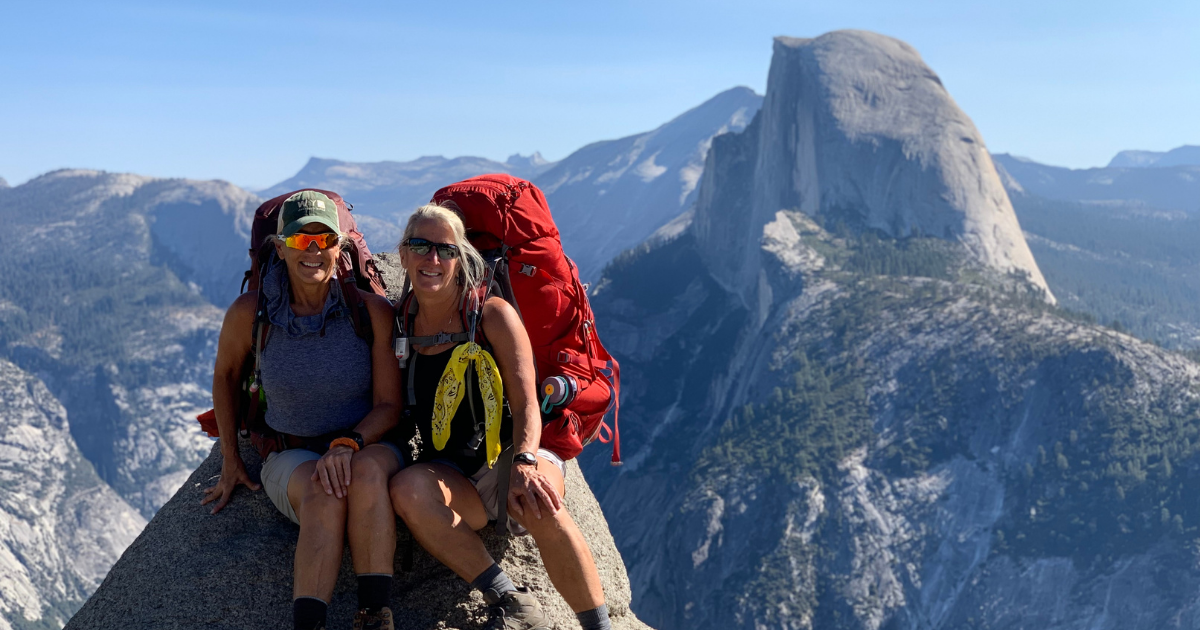 Two women backpacking near Half Dome in Yosemite National Park on an Explorer Chick small-group guided women’s trekking trip